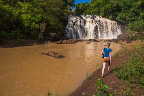 Argentina Travel Landscape Photography People at Waterfall connecting a tributary with the Rio Parana Parana River near Puerto Iguazu Misiones Province Argentina South America