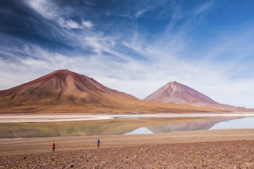 Bolivia Travel Landscape Photography Tourists at Licancabur volcano right and Laguna Verde Bolivia near the border to Chile South America