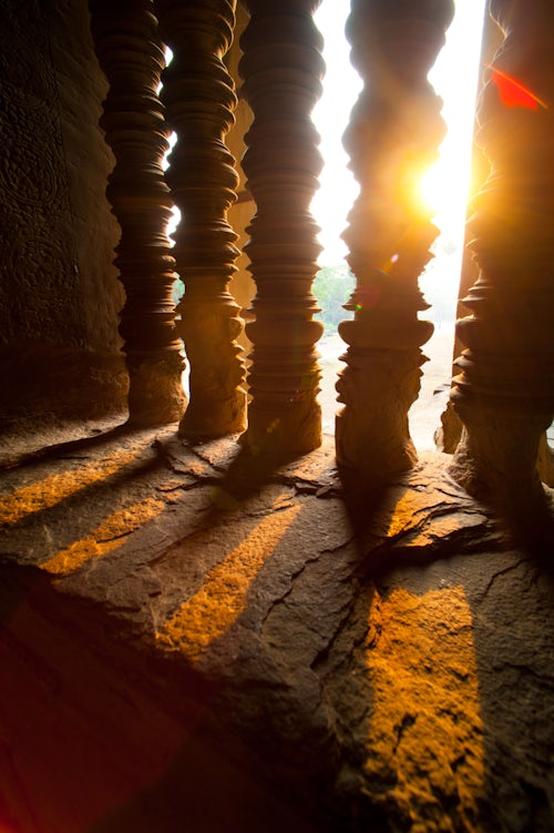 Cambodia Travel Photography Sunset Through Stone Pillars at Angkor Wat Cambodia Southeast Asia