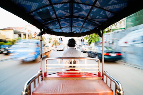 Cambodia Travel Photography Tuktuk driver speeding along the roads of Phnom Penh Cambodia Southeast Asia Asia Southeast Asia
