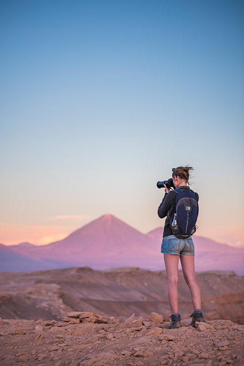 Chile Travel Landscape Photography Person taking a photo at sunset of Licancabur Volcano 5920m sunset Atacama Desert North Chile South America