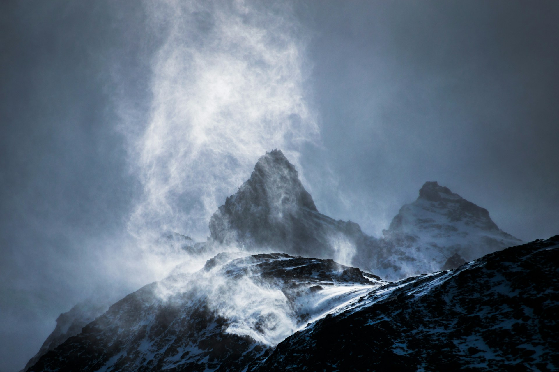 Chile Travel Landscape Photography Wind sweeping snow off mountains Torres del Paine National Park Patagonia Chile South America