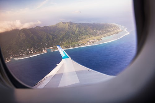 Cook Islands Landscape Travel Photography Aerial photo of tropical Rarotonga Island seen from the airplane window behind the aeroplane wing Cook Islands