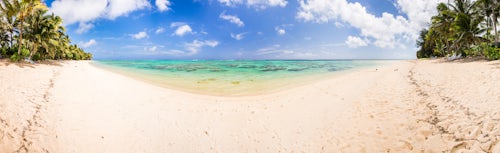 Cook Islands Landscape Travel Photography Crystal clear Pacific Ocean water and tropical white sandy beach with palm trees at Titikaveka Rarotonga Cook Islands background with copy space