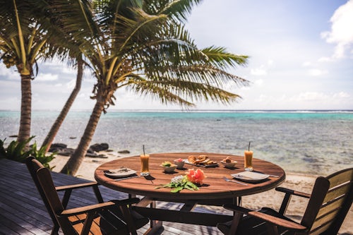 Cook Islands Landscape Travel Photography Luxury Villa accommodation with sea views of the tropical Pacific ocean and palm trees with breakfast table set up at the hotel Muri Rarotonga Cook Islands