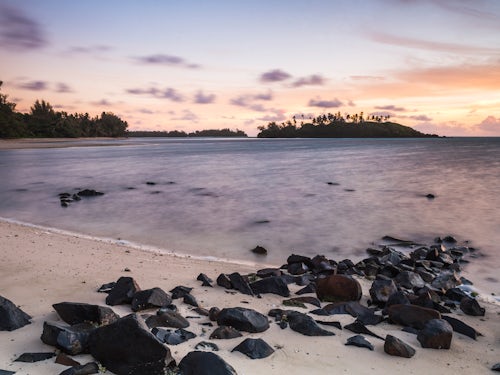 Cook Islands Landscape Travel Photography Sunrise at Muri Beach and tropical Motu Taakoka Island Rarotonga Cook Islands background with copy space