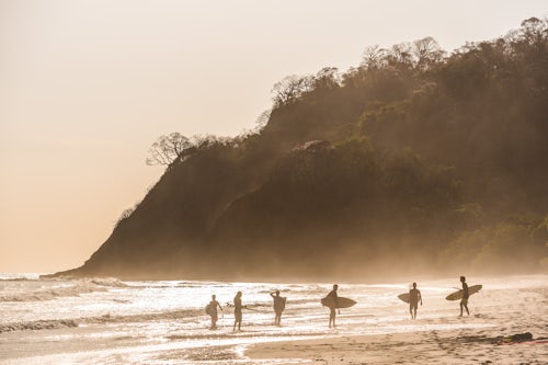 Costa Rica Travel Landscape Photography Surfers surfing on a beach at sunset Nosara Guanacaste Province Pacific Coast Costa Rica 2