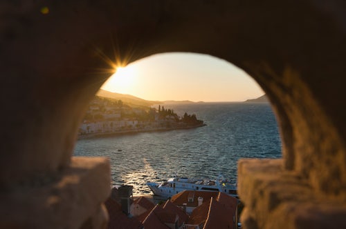 Croatia Travel Photography Korcula Town sunstar at sunset from St Marks Cathedral bell tower Korcula Island Dalmatia Dalmacija Croatia