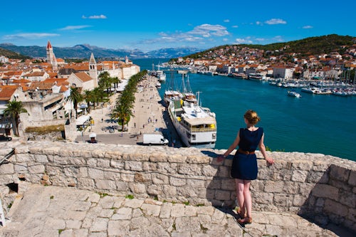 Croatia Travel Photography Photo of a tourist admiring the view from Kamerlengo Fortress Gradina Kamerlengo over Trogir water front Dalmatian Coast Croatia Europe
