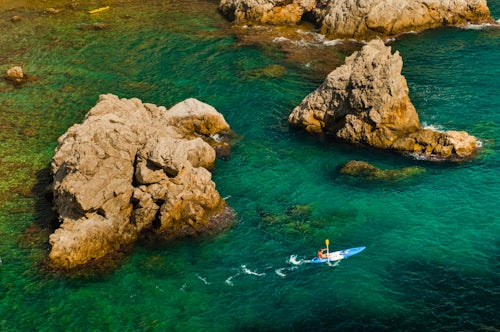 Croatia Travel Photography Sea Kayaking in Dubrovnik a tourist kayaking in the Mediterranean Sea Croatia