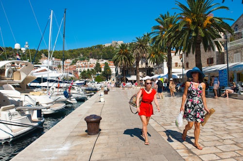 Croatia Travel Photography Tourists on a luxury holiday at Hvar Town Harbor Hvar Island Dalmatian Coast Croatia