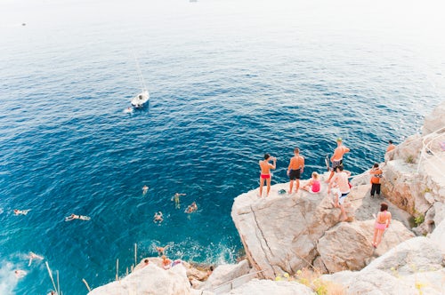 Croatia Travel Photography Tourists swimming at Buza Bar aka Cafe Buza Dubrovnik Croatia