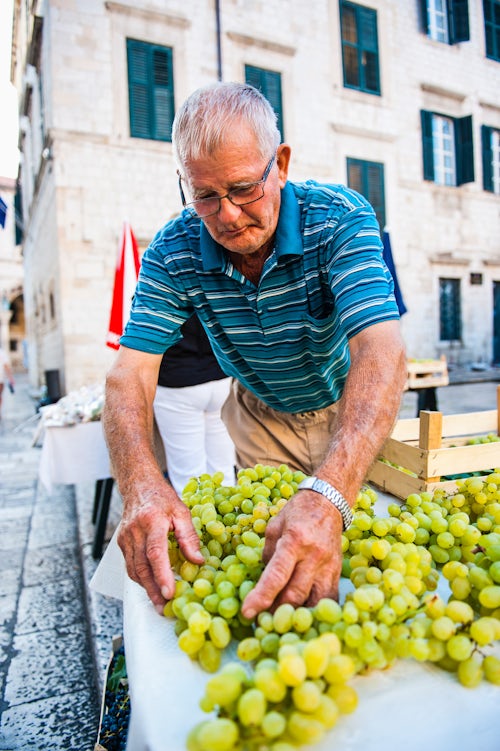 Croatia Travel Photography Vendor at Dubrovnik Market aka Gundulic fruit market in Gundulic Square Dubrovnik