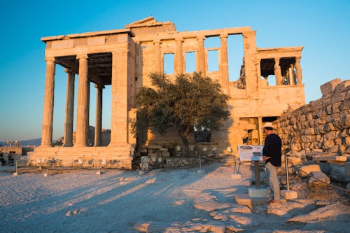 Greece Travel Photography Tourist man sightseeing at the Acropolis at sunset on summer vacation Athens Attica Region Greece UNESCO World Heritage Site Europe