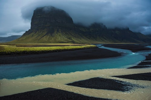 Iceland Landscape Photography Confluence of glacial river in dramatic Iceland landscape with rock formations and mountains seen from Route 1 in South Region Sudurland Europe