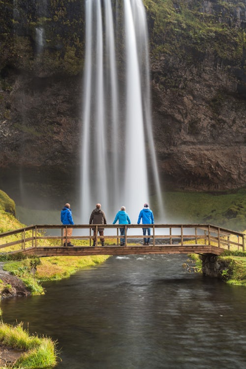Iceland Travel Photography Family at Seljalandsfoss a famous waterfall just off route 1 in South Iceland Sudurland