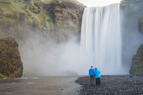 Iceland Travel Photography Mother and son at Skogafoss Waterfall Skogar South Region Sudurland Iceland