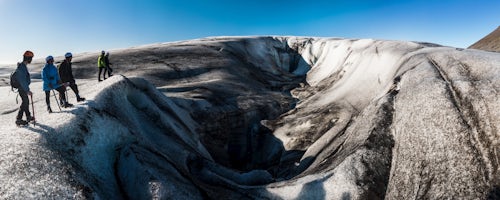 Iceland Travel Photography Tourist exploring Breidamerkurjokull Glacier Vatnajokull Ice Cap Iceland Europe