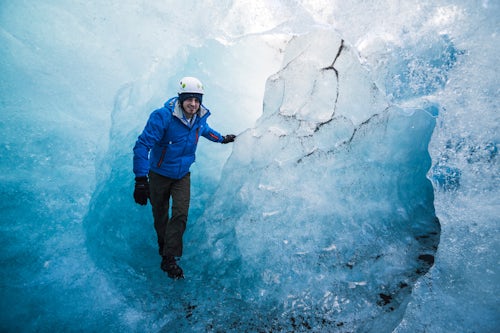 Iceland Travel Photography Tourist exploring an ice cave on Breidamerkurjokull Glacier Vatnajokull Ice Cap Iceland