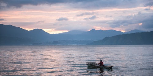 Indonesia Travel Photography Fisherman in a fishing boat on Lake Toba Danau Toba at sunrise North Sumatra Indonesia Asia