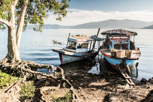 Indonesia Travel Photography Old rusty fishing boats in a village at Lake Toba Danau Toba North Sumatra Indonesia Asia