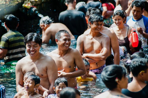Indonesia Documentary Travel Photography The Biggest Smile in Indonesia a Balinese Man in The Sacred Pool at Pura Tirta Empul Temple Bali Indonesia Asia