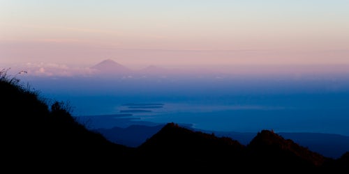 Indonesia Landscape Travel Photography Panoramic Landscape Photography of the Sunset Behind Mount Agung and Mount Batur on Bali and the Three Gili Isles Mount Rinjani Trek Lombok Indonesia Asia background with copy space