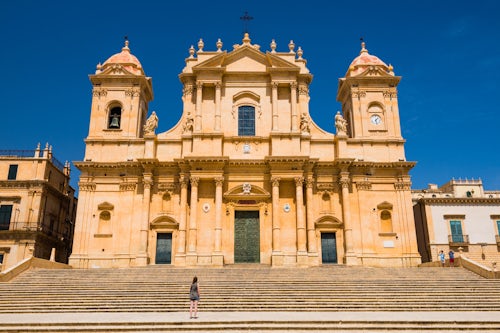 Italy Sicily Travel Photography Noto Sicily a tourist visiting St Nicholas Cathedral Noto Cathedral Cattedrale di Noto a Baroque building in Noto Sicily Italy Europe