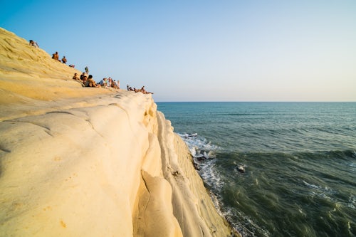 Italy Sicily Travel Photography Scala dei Turchi tourists watching the sun set Rossello cape Realmonte Agrigento Sicily Italy Europe