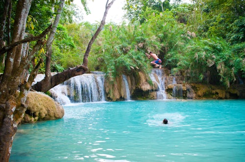 Laos Travel Photography Tourist Swimming at the Kuang Si Waterfalls Luang Prabang Loas Southeast Asia
