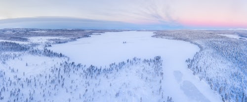 Lapland Finland Drone Landscape Photography Snow covered lake and forest winter landscape showing amazing Lapland scenery in Scandinavia in Finland drone