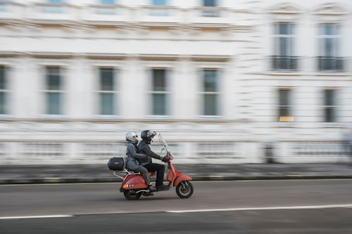 London Street Photography Moped driving through the streets on London England