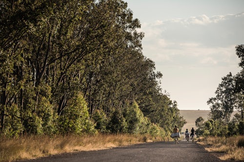 Madagascar Documentary Travel Photography People cycling on RN7 Nationale Route 7 near Isalo National Park Southwestern Madagascar