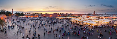 Morocco Travel Photography Food stalls people and Koutoubia Mosque at sunset Place Djemaa El Fna Square Marrakech Marrakesh Morocco North Africa Africa