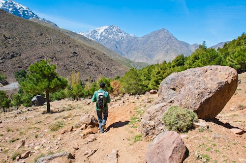 Morocco Travel Photography Tour guide trekking at Imlil valley descending from Tizi n Tamatert into Imlil High Atlas Mountains Morocco North Africa Africa