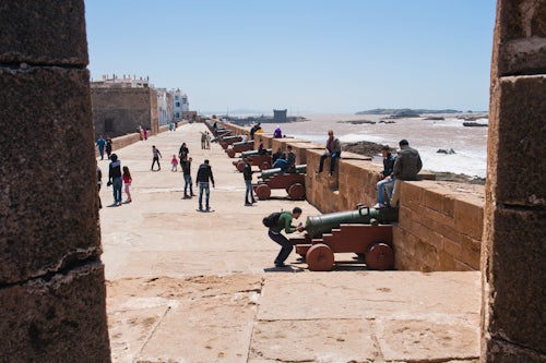 Morocco Travel Photography Tourist visiting the old canons on the North Bastion section of the ramparts Essaouira formerly Mogador UNESCO World Heritage Site Morocco Africa