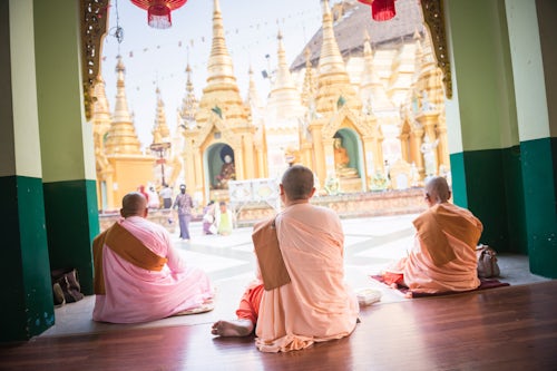 Myanmar Burma Travel Photography Buddhist Nuns praying at Shwedagon Pagoda aka Shwedagon Zedi Daw or Golden Pagoda Yangon Rangoon Myanmar Burma