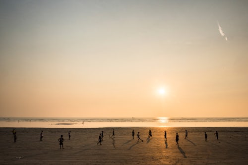 Myanmar Burma Travel Photography Playing football on Maungmagan Beach at sunset Dawei Tanintharyi Region Myanmar Burma