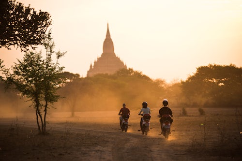 Myanmar Burma Travel Photography Temples of Bagan Pagan at sunrise tourists explore on electric bikes Myanmar Burma