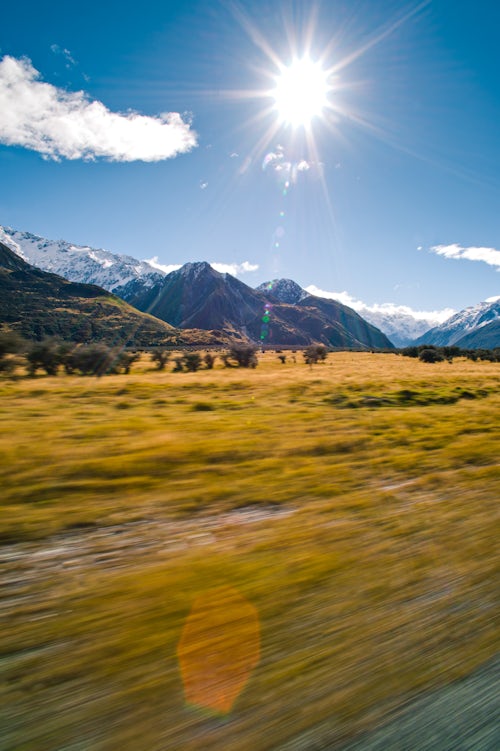 New Zealand Landscape Photography Driving on a road trip adventure through the Snow Capped Mountains landscape of Aoraki Mount Cook National Park South Island New Zealand