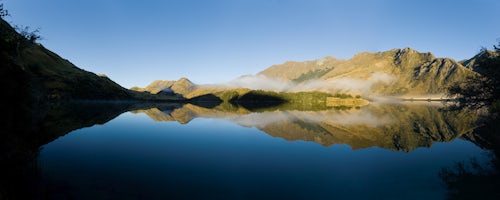 New Zealand Landscape Photography Panoramic Photo of Misty Dawn Reflections in a Calm Lake Moke Queenstown South Island New Zealand