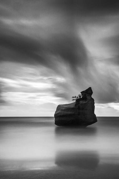 New Zealand Landscape Photography Black and white landscape photo of ocean and rock formations on the coast at Cathedral Cove Beach Coromandel Peninsula New Zealand North Island Long exposure