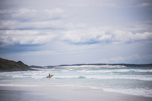 New Zealand Travel Photography Surfer surfing at Rarawa Beach a popular and beautiful white sand beach in Northland Region North Island New Zealand