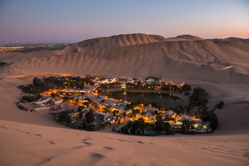 Peru Travel Photography Huacachina surrounded by sand dunes at night Ica Region Peru South America
