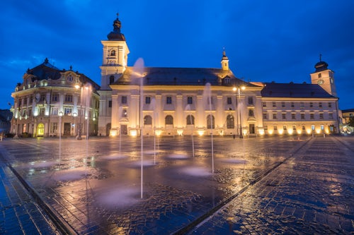 Romania Architecture Travel Photography Piata Mare Great Square at night with Sibiu City Hall on left and Sibiu Baroque Jesuit Church on right Transylvania Romania
