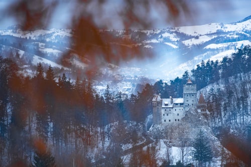 Romania Landscape Travel Photography Bran Castle covered in snow in winter Transylvania Romania