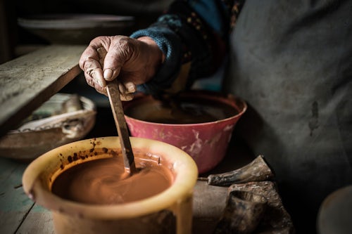 Romania Travel Photography Woman making Horezu ceramics a unique type of Romanian pottery UNESCO Cultural Heritage List Wallachia Romania
