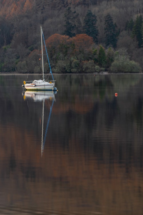 Scotland Landscape Photography Sailing boat on Loch Tay in autumn Kenmore Perthshire Highlands of Scotland United Kingdom Europe