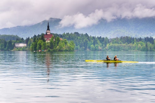 Slovenia Travel Photography Rowers rowing by Lake Bled Island Gorenjska Upper Carniola Region Slovenia Europe
