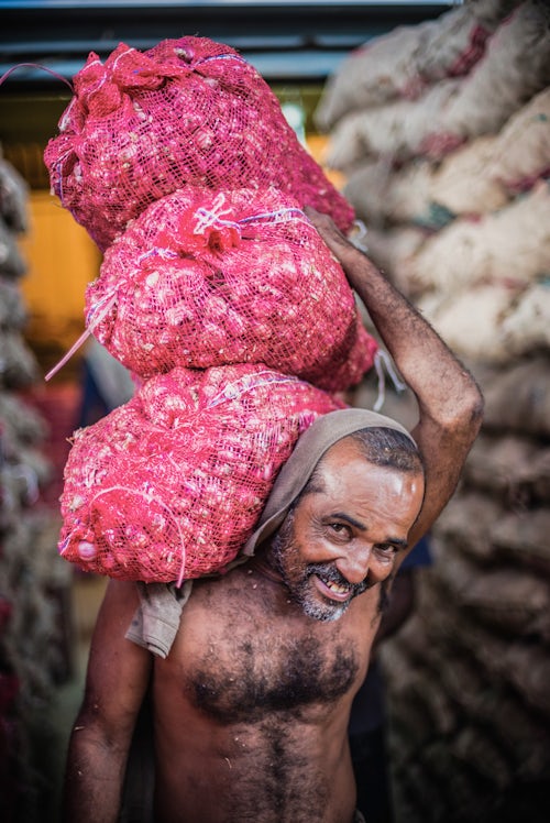 Sri Lanka Portrait Travel Photography Man carrying vegetables at Dambulla vegetable and produce market in Dambulla Central Province Sri Lanka Asia